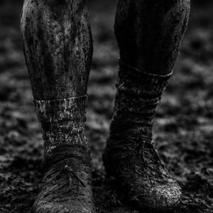 Mud-Spattered Legs After the Match